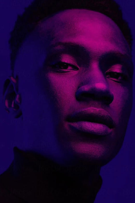Neon portrait: Close-up of a man's face, illuminated in pink and purple hues.